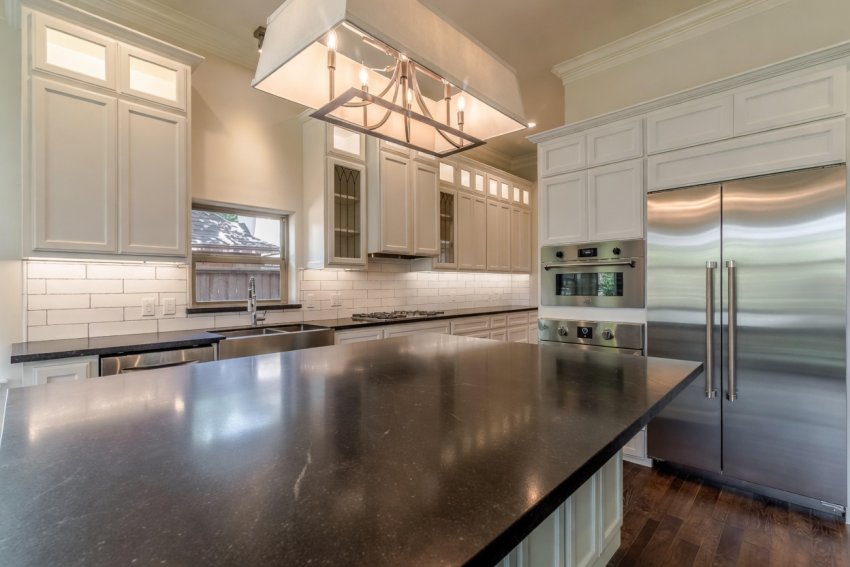 Luxury custom white painted kitchen cabinets in a bright, spacious Texas home