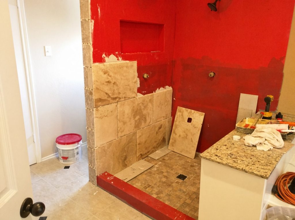 Travertine tile install during master bathroom shower remodel in Spring TX