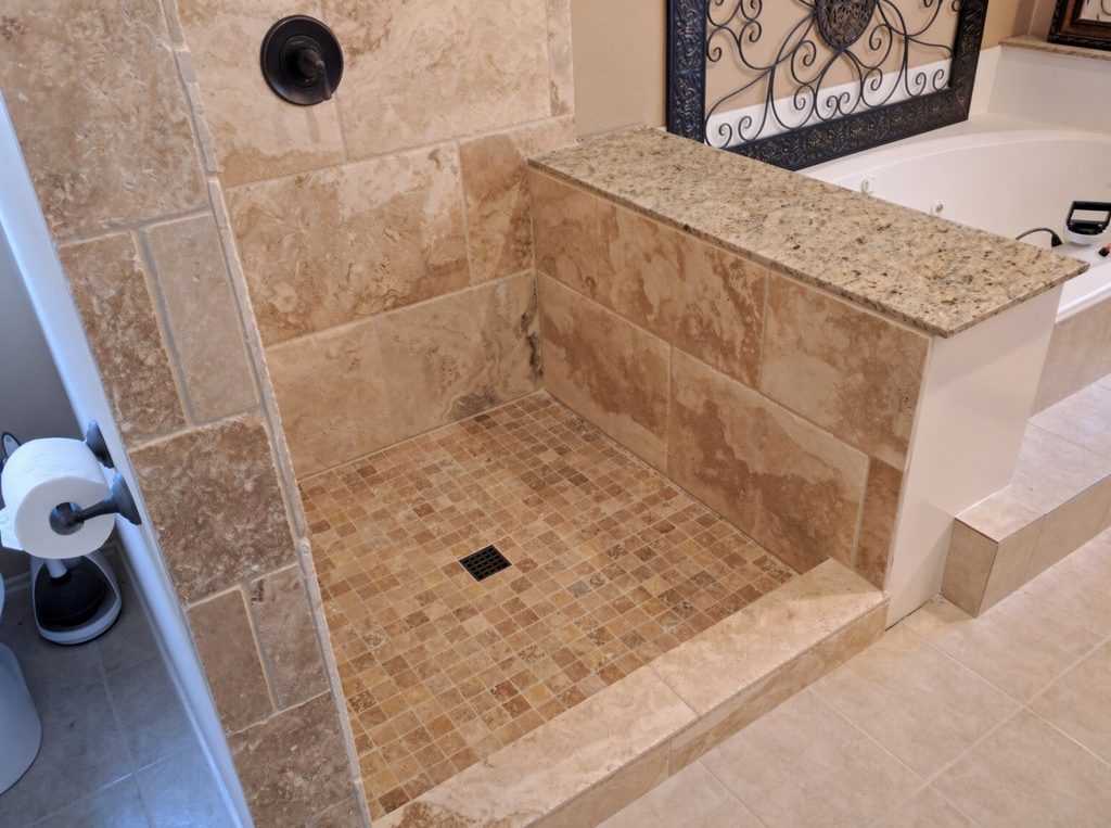 Travertine tile install during master bathroom shower remodel in Spring TX