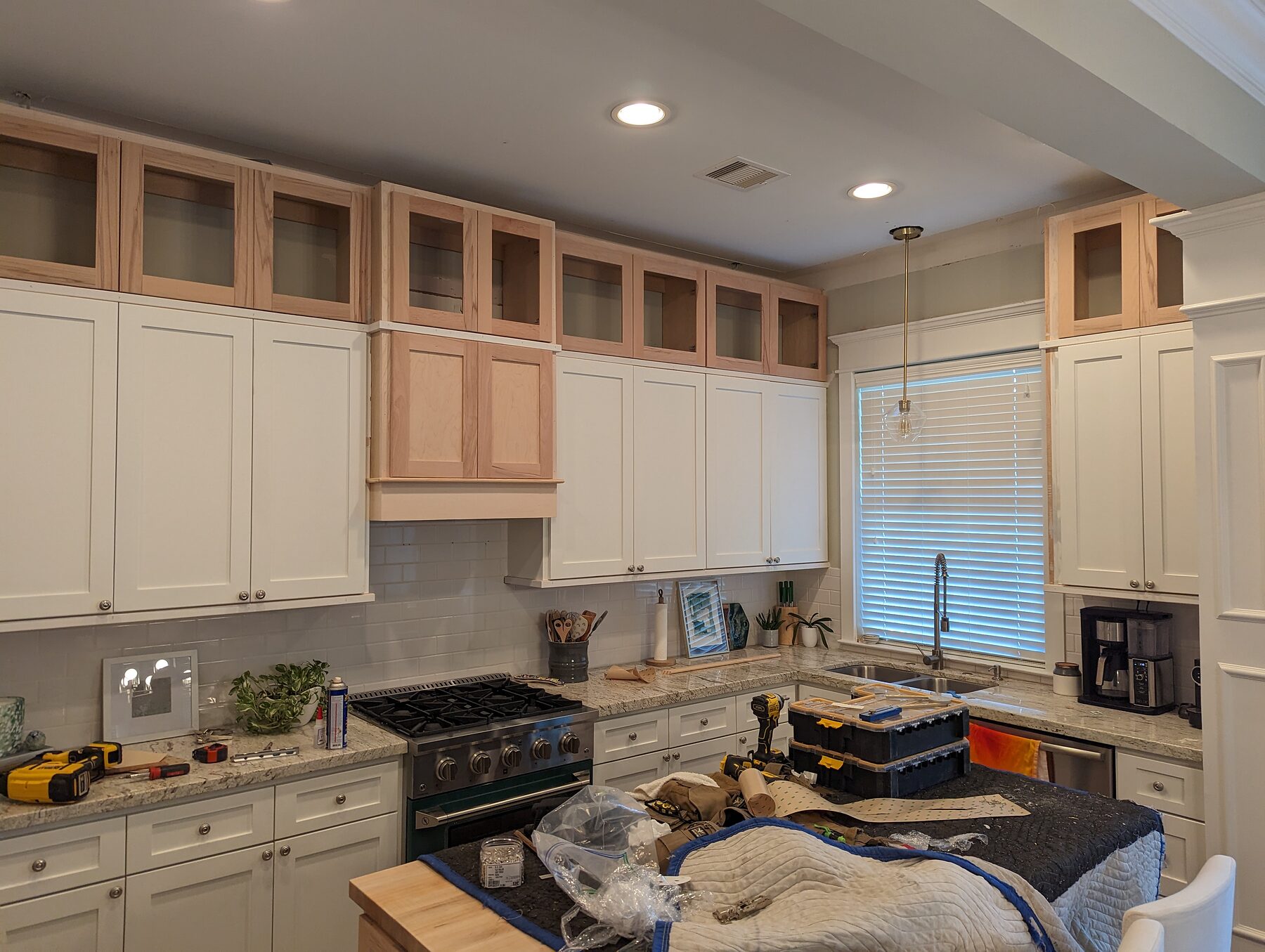 Custom hood cabinet and toppers mid-install in a Houston Heights kitchen