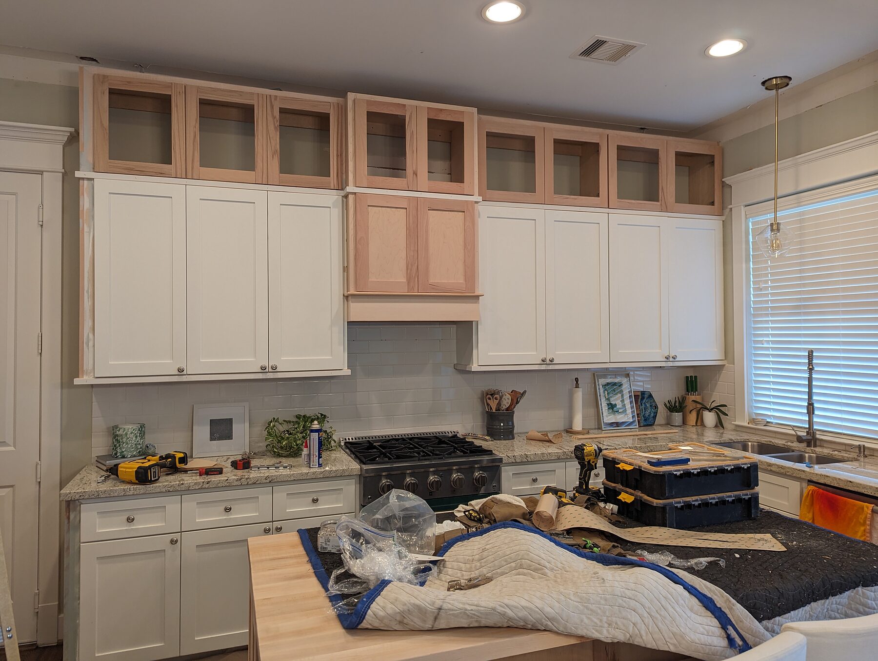 Glass-door cabinet toppers installed over existing cabinets in Houston Heights