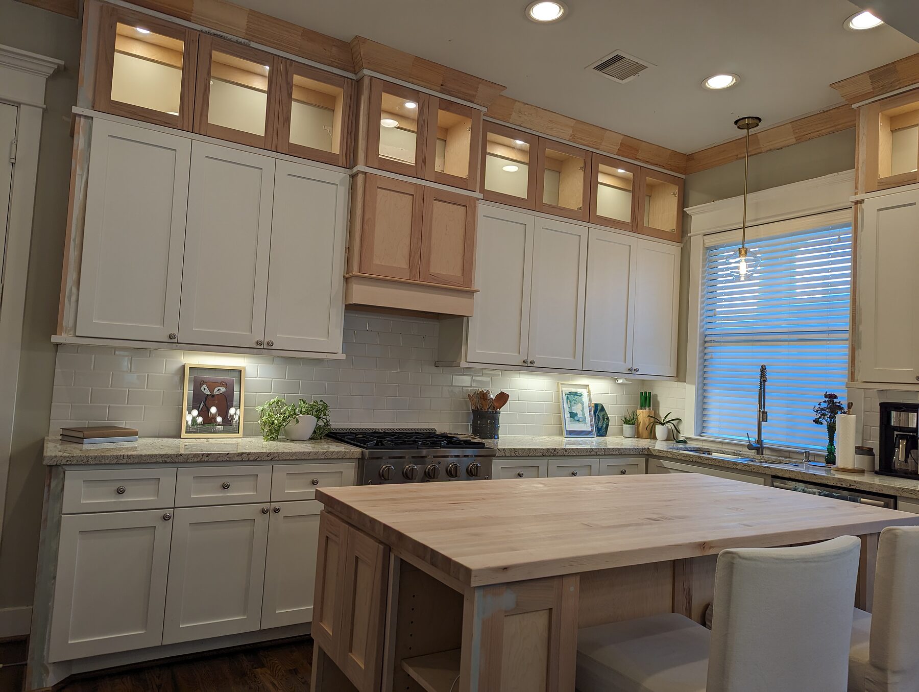 Custom kitchen island and glass-door cabinet toppers in Houston Heights