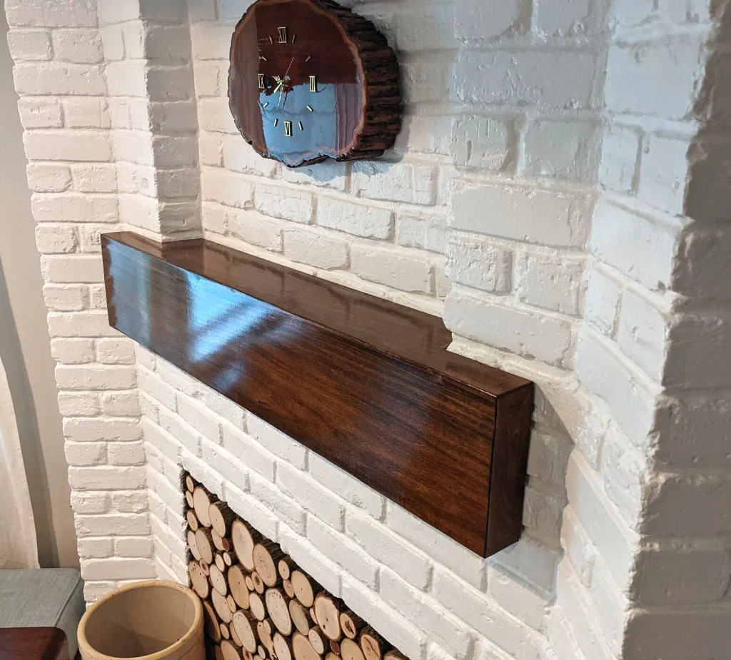 Detail of a faux beam mantel notched to follow the brick reveal instead of sitting proud of the wall.