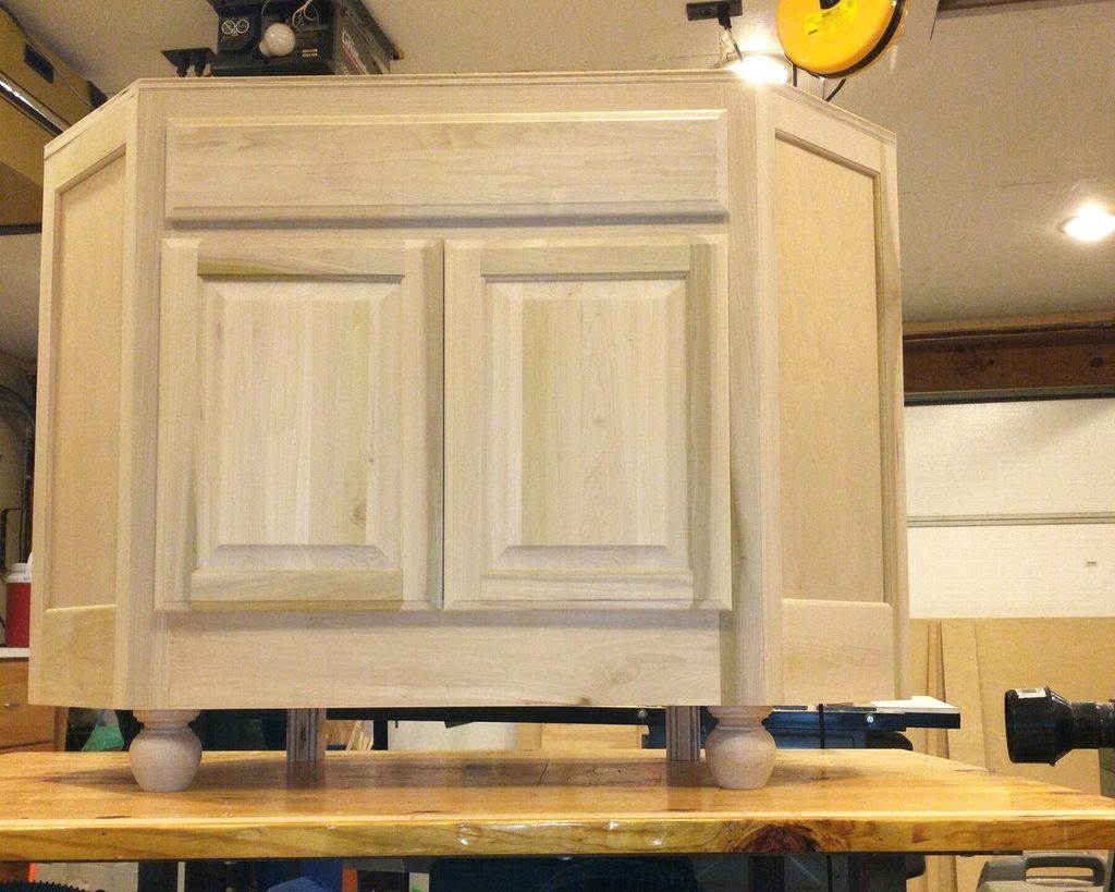 unfinished: Custom guest vanity assembled in the shop, still raw wood, bun feet on.