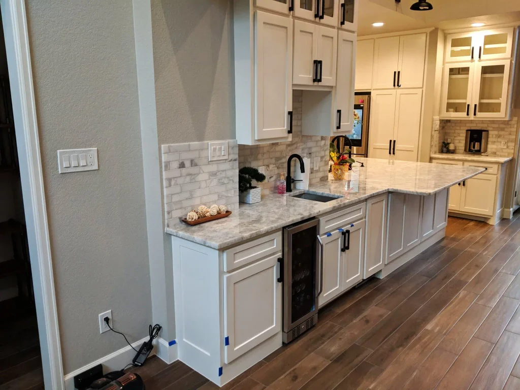 Built beverage wall with fridge and storage in the Spring TX kitchen remodel.