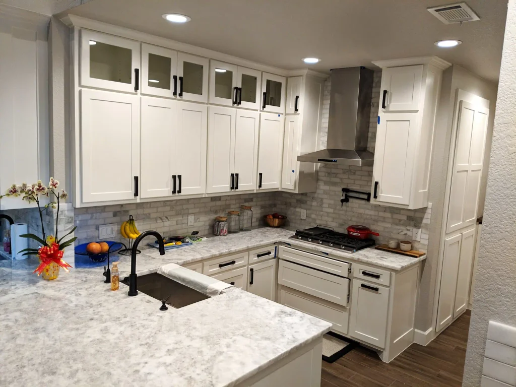 Built cooking area of the Spring TX kitchen — range, ovens, and work triangle.