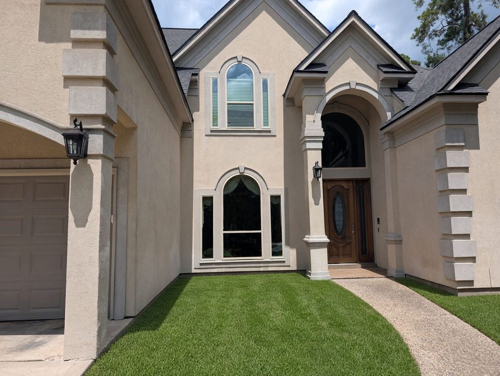 Custom arched window installation on a stucco home in The Woodlands, TX