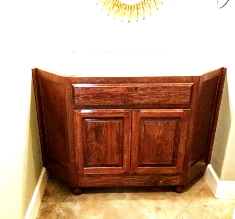 After: stained custom guest vanity built to fit angled walls