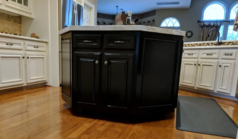 Low-angle view of a black kitchen island with raised-panel doors and drawers, Estates at Windrush, Spring TX