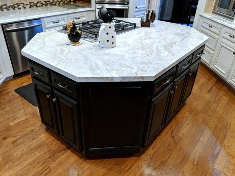 Black octagonal kitchen island with a light quartzite countertop in a white kitchen, Estates at Windrush, Spring TX