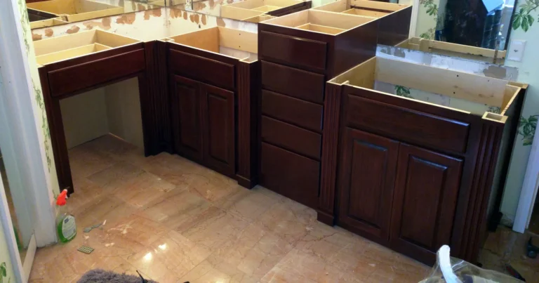 Stained L-shaped custom master bath vanity with knee space, drawer bank and raised section, before tops, Champions South, Spring TX