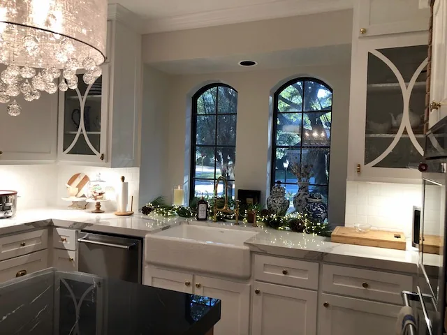 White custom cabinets with arched glass uppers around a farmhouse sink, Huntwick Forest, Spring TX