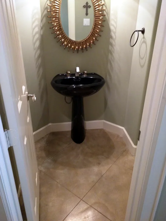 Before: guest powder bath with a pedestal sink and no storage