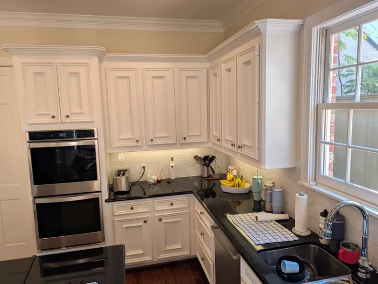Before: double wall ovens and raised-panel cabinets that stopped short of the ceiling, West University Place