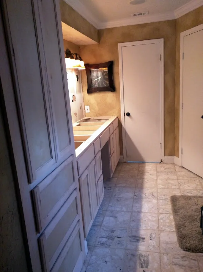 Custom bathroom vanity with knee space and a full-height linen tower with drawers, installed unpainted before tops, Champions Forest, Spring/Klein TX