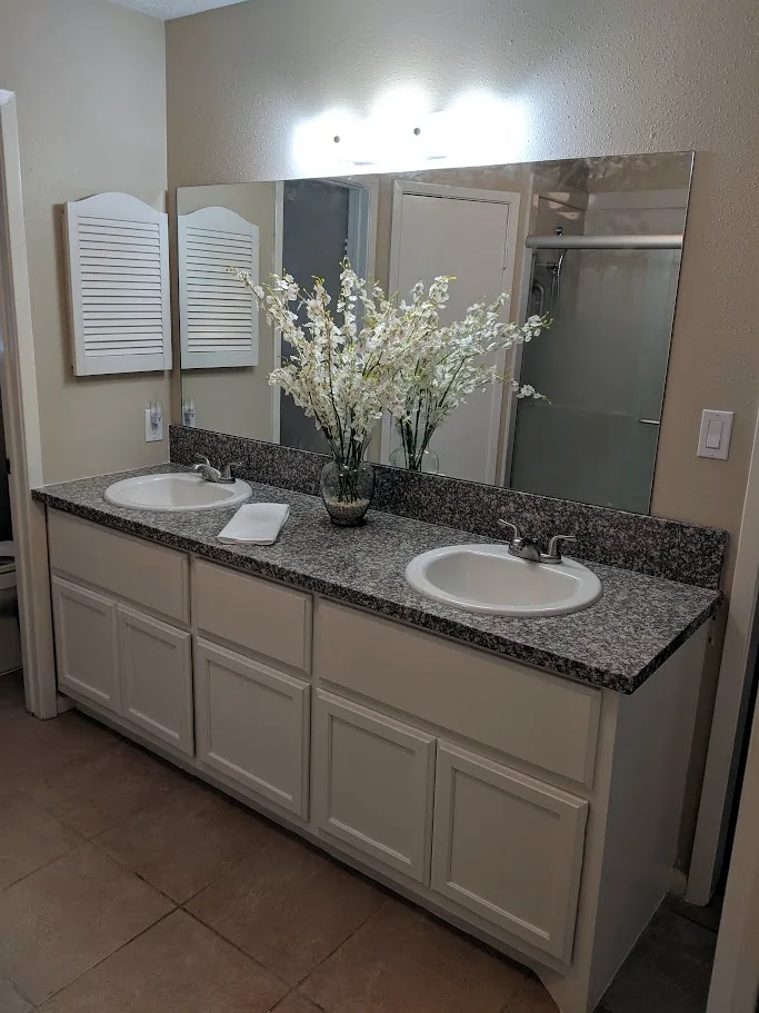 Finished painted white double-sink custom vanity in an Oakwood Glen home in Spring, TX