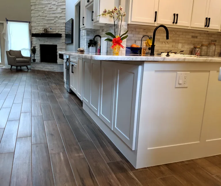 Low view of a white shaker-style peninsula with paneled ends and a marble-look countertop, The Parks at Cypresswood, Spring TX